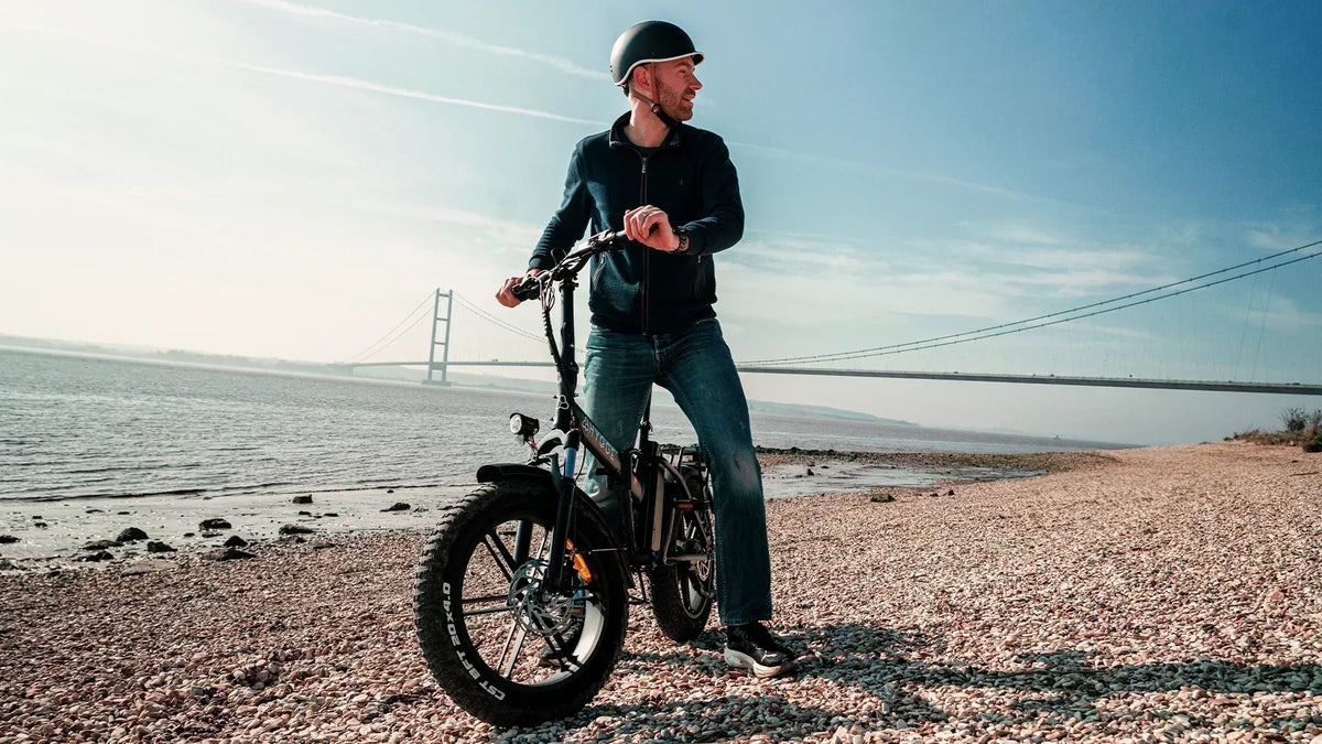 Hygge Vester fat tyre folding electric bike on a coastal path, showcasing all-terrain capability and comfort for UK riders