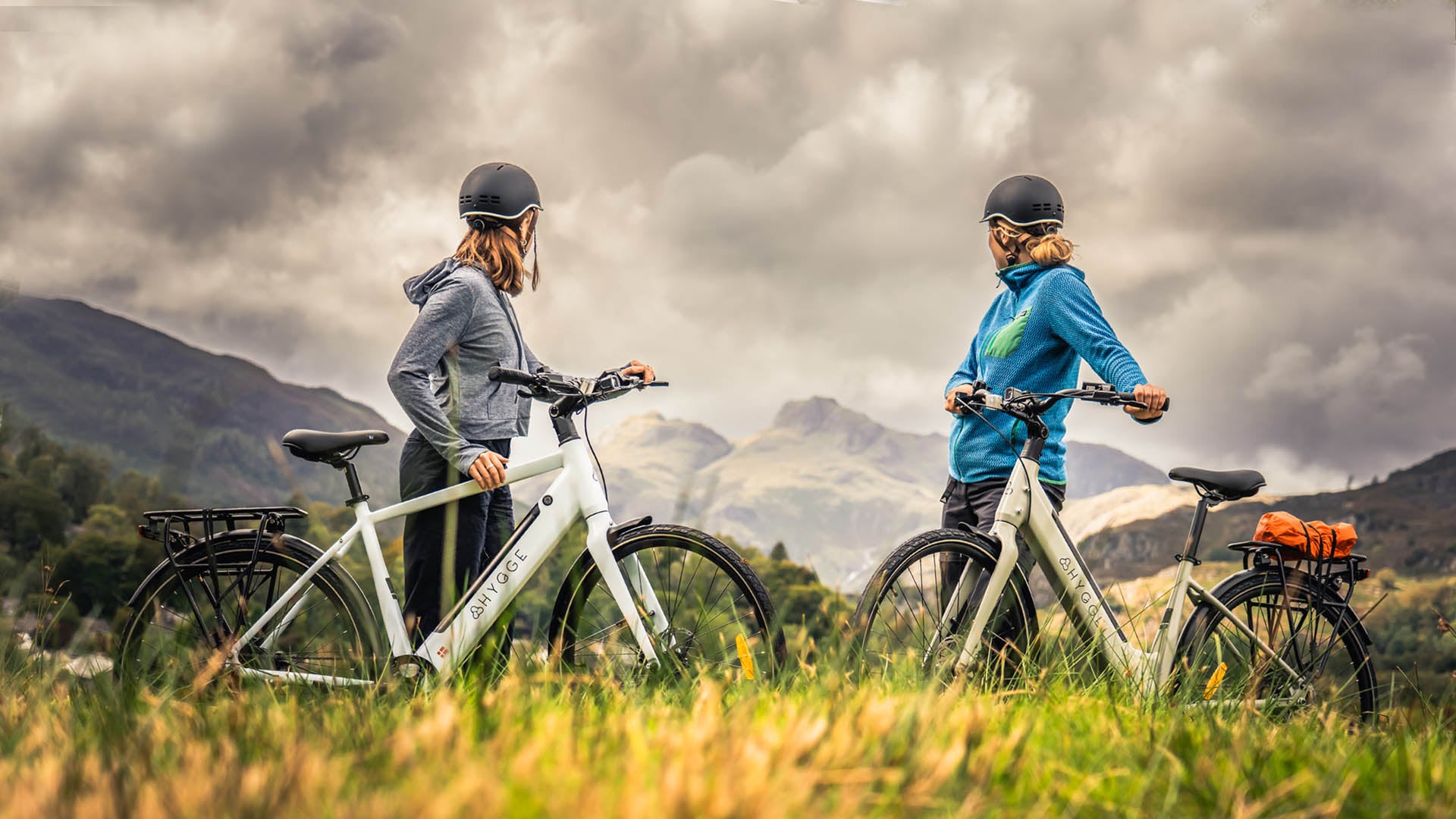Riders with Hygge Losso and Nivø urban city e-bikes in scenic mountain landscape