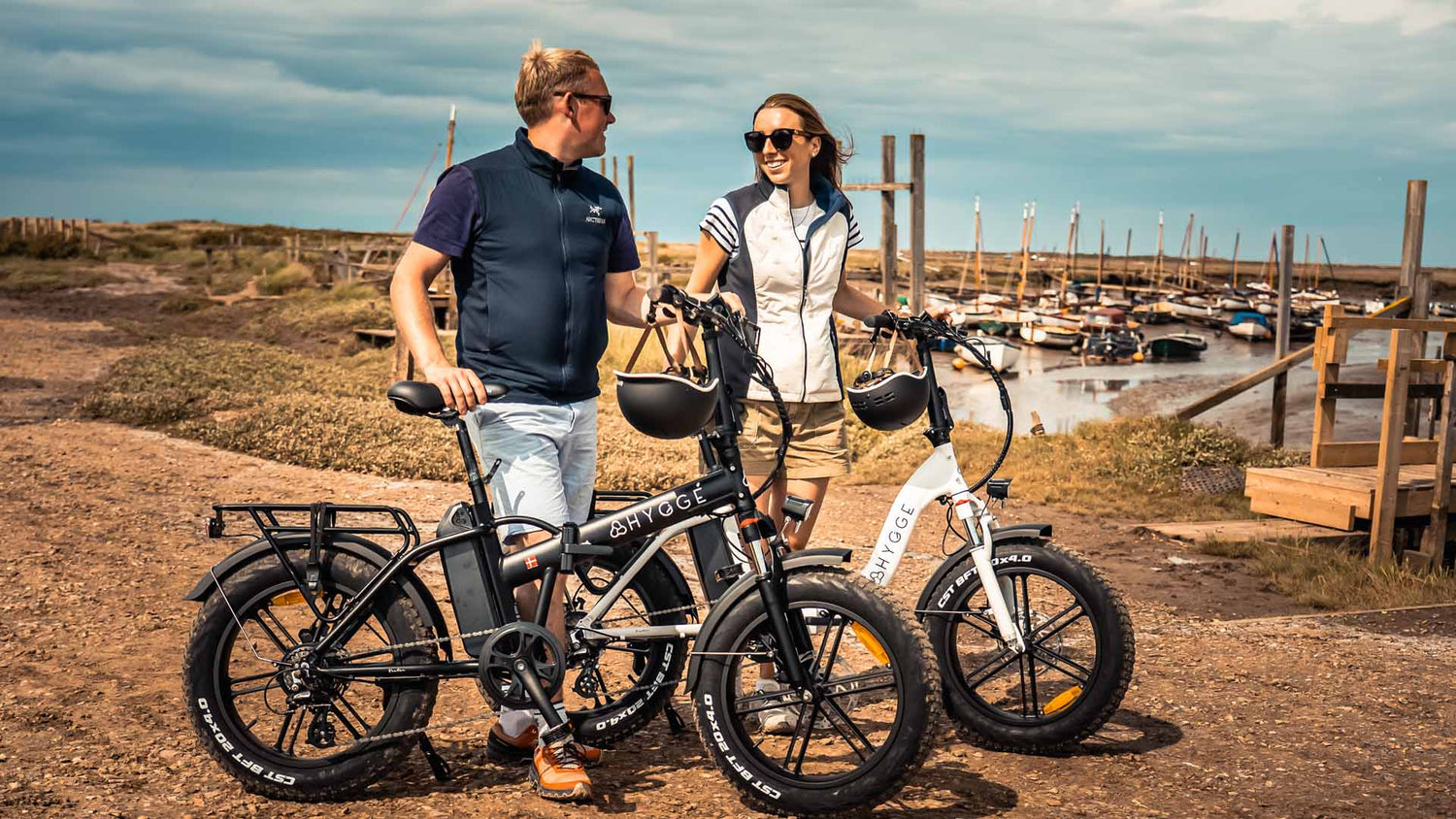 Couple with Hygge Vester series All terrain folding e-bikes, showcasing comfort, reliability, and adventure-ready design.